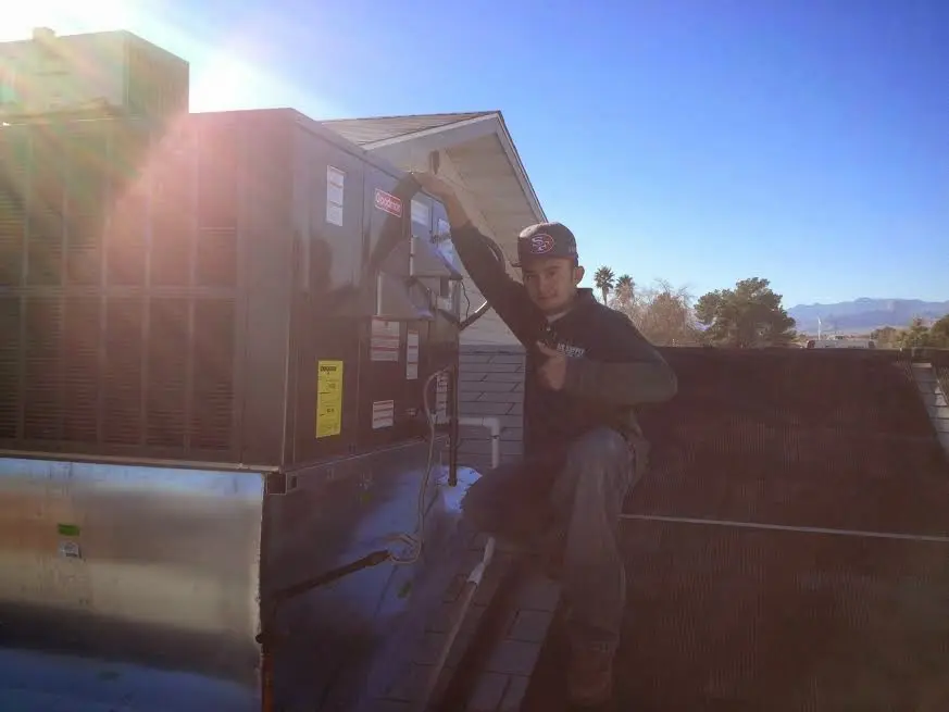 HVAC technician performing Boiler Repair on a rooftop unit in Garden City